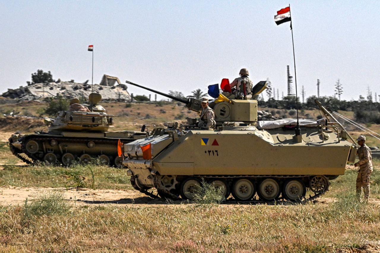An Egyptian army M60 main battle tank and an infantry fighting vehicle (IFV) deployed near Egyptian side of the Rafah border crossing, March 23, 2024. (AFP Photo)
