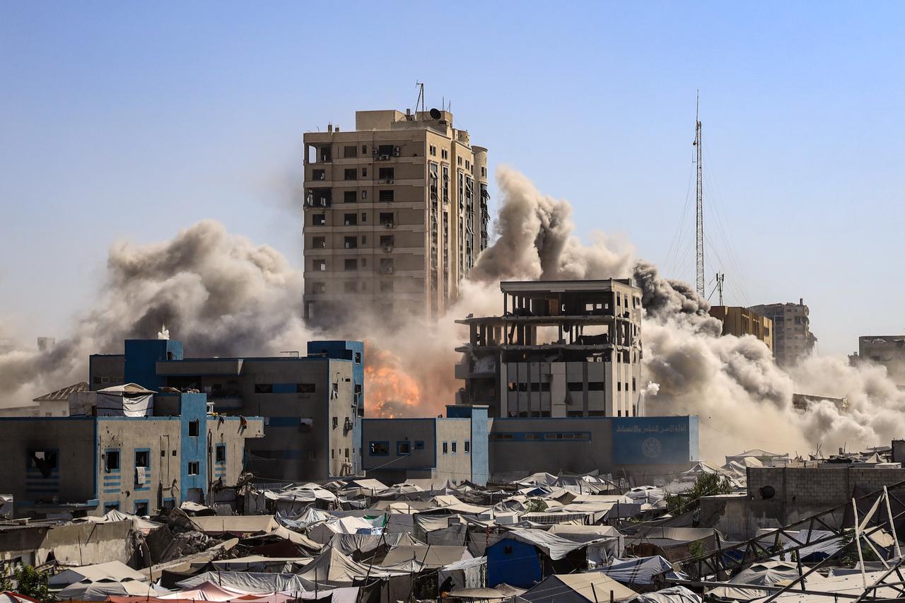 Smoke rises from a seven-story building known as the Al-Roya Tower after the Israeli military targeted it with an airstrike in Gaza City, Gaza, on September 08, 2025. (AA Photo)