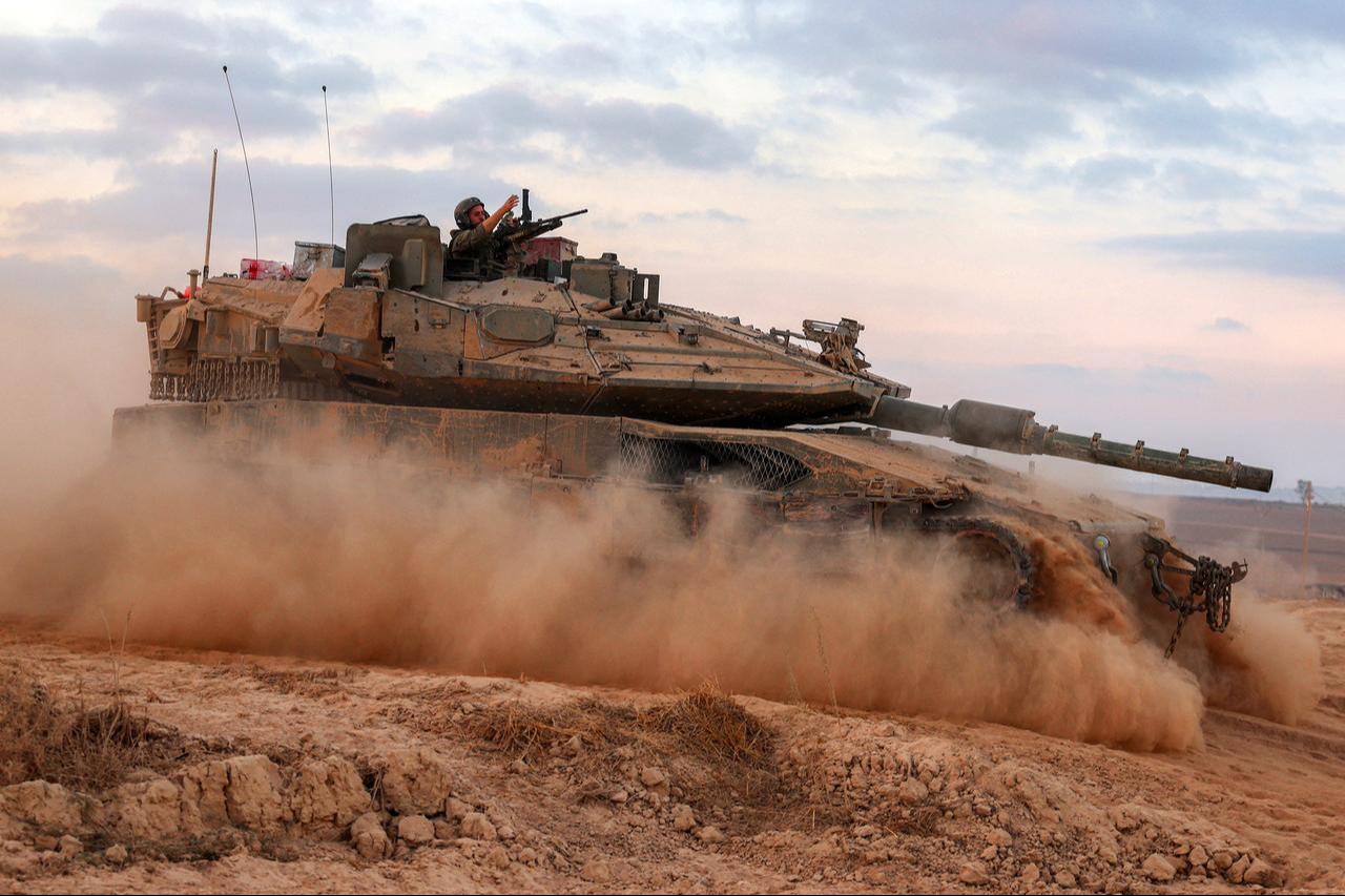 An Israeli army soldier gestures from turret of a Merkava main battle tank moving at a position along border fence with Gaza Strip in southern Israel, Sept. 12, 2025. (AFP Photo)