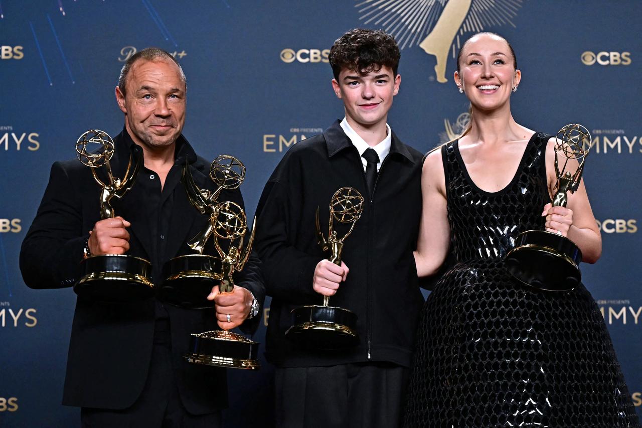 Stephen Graham, Owen Cooper, and Erin Doherty pose with their Emmys for Adolescence at the 77th Primetime Emmy Awards at the Peacock Theater in Los Angeles, September 14, 2025. (Photo by Frederic J. Brown / AFP)