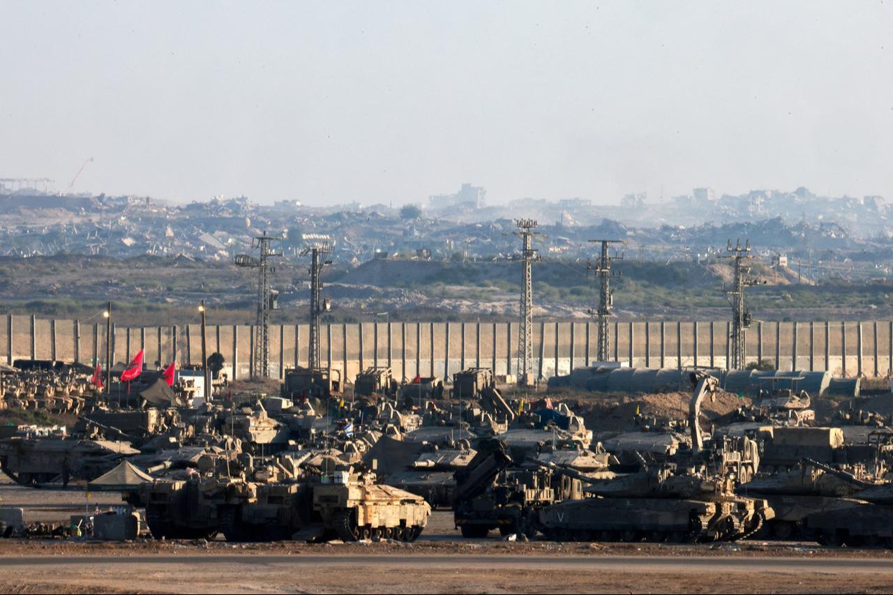 Stationed Israeli military armoured vehicles with a view of destroyed buildings in the besieged Palestinian territory, Sept. 16, 2025. (AFP Photo)