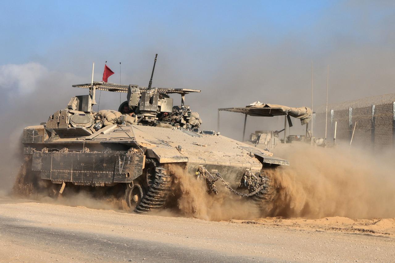This picture taken from a position at Israel's border with the Gaza Strip shows Israeli military vehicles by the border fence in the besieged Palestinian territory, September 16, 2025. (AFP Photo)