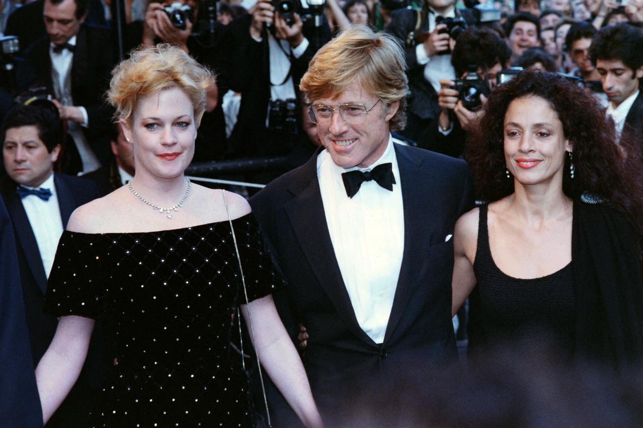 (From L to R), American actress Melanie Griffith, American actor and director Robert Redford, and Brazilian actress Sônia Braga during the Tapis Rouge, for the movie "The Milagro Beanfield War" at the 41th edition of the Cannes Film Festival in Cannes, southern France on May 15, 1988. (AFP Photo)