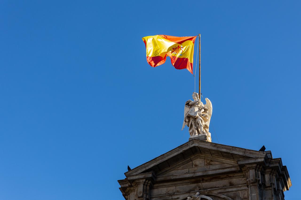 Michael statue holds the Spanish national flag above the main pediment of Viana Palace (Santa Cruz Palace), the official residence of the Ministry of Foreign Affairs in Madrid, Spain, accessed on Sept. 16, 2025. (Adobe Stock photo)