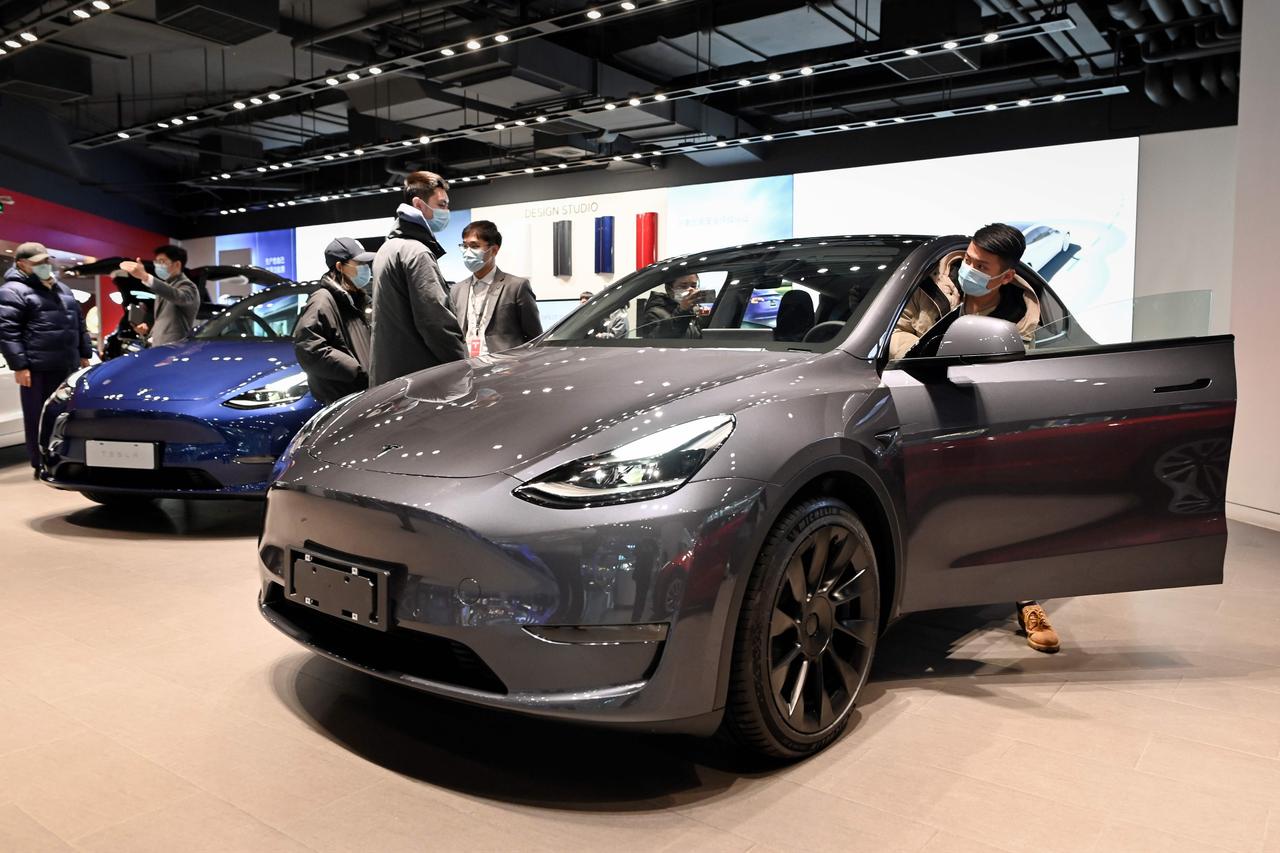 People look at a Tesla Model Y car at a Tesla showroom in Beijing on January 5, 2021. (AFP Photo)
