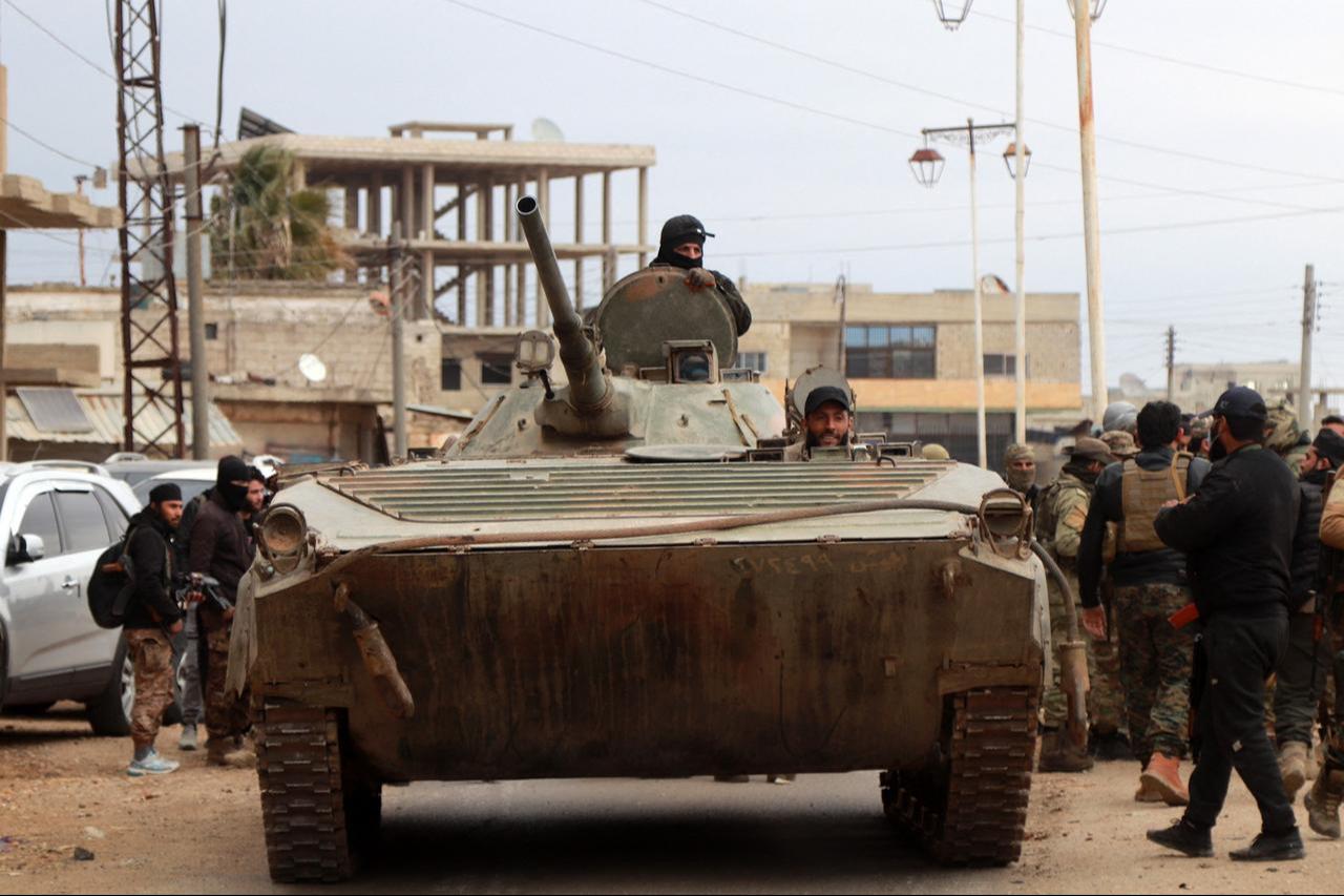 Members of Syria's security forces gather in Sanamayn, in the southern province of Daraa, during a reported large scale military campaign on March 5, 2025. (AFP Photo)
