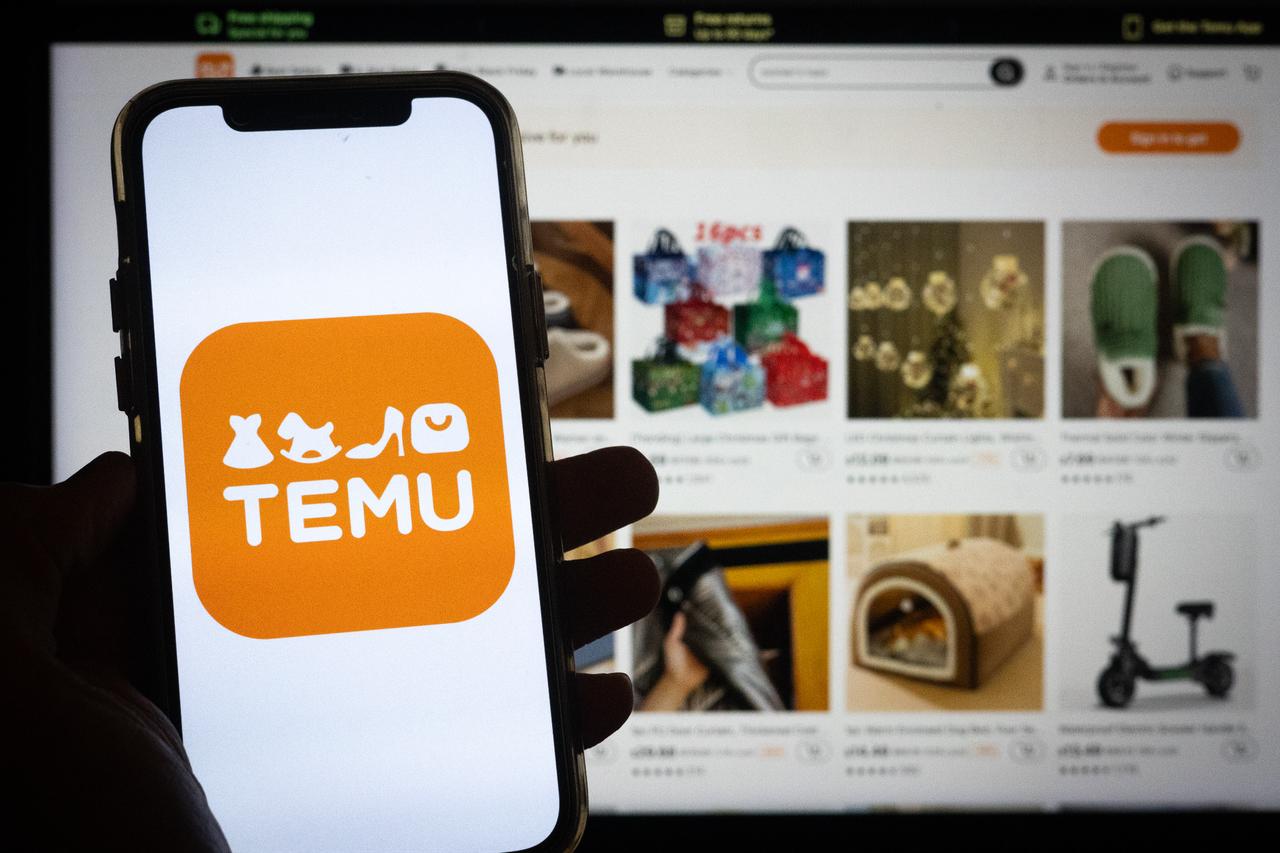 Photo illustration shows the Temu shopping app logo displayed on a smartphone, with the platform’s online marketplace in the background. (Adobe Stock Photo)