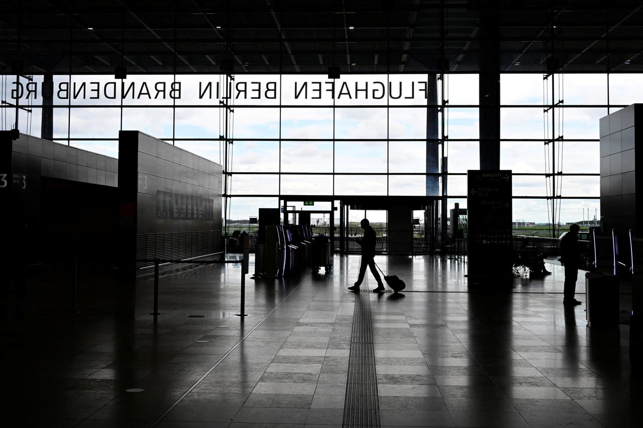 A passenger walks through the nearly empty main terminal of Berlin Brandenburg Airport (BER) in Schoenefeld, near Berlin, Germany, April 24, 2023. (AFP Photo)