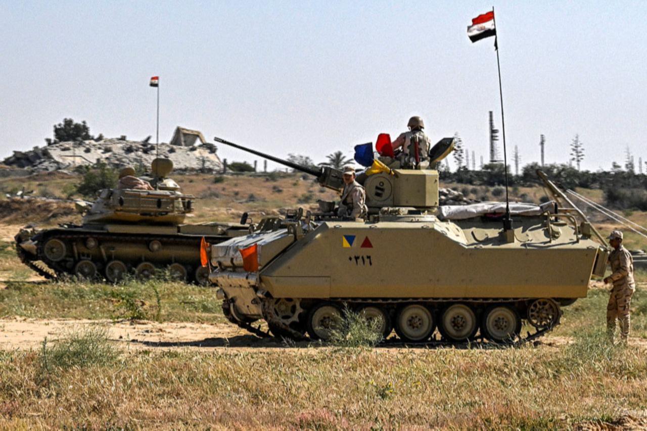 An Egyptian army M60 main battle tank and an infantry fighting vehicle (IFV) deployed near Egyptian side of the Rafah border crossing, March 23, 2024. (AFP Photo)