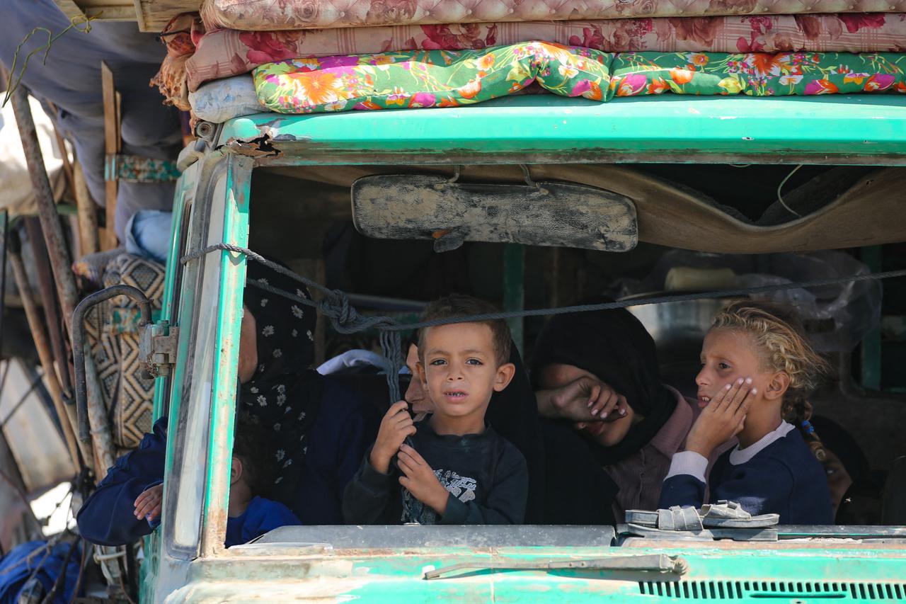 Palestinians from Gaza City ride in a truck as they move southwards with their belongings, on the coastal road near the Nuseirat refugee camp in the central Gaza Strip, Sept. 19, 2025. (AFP Photo)