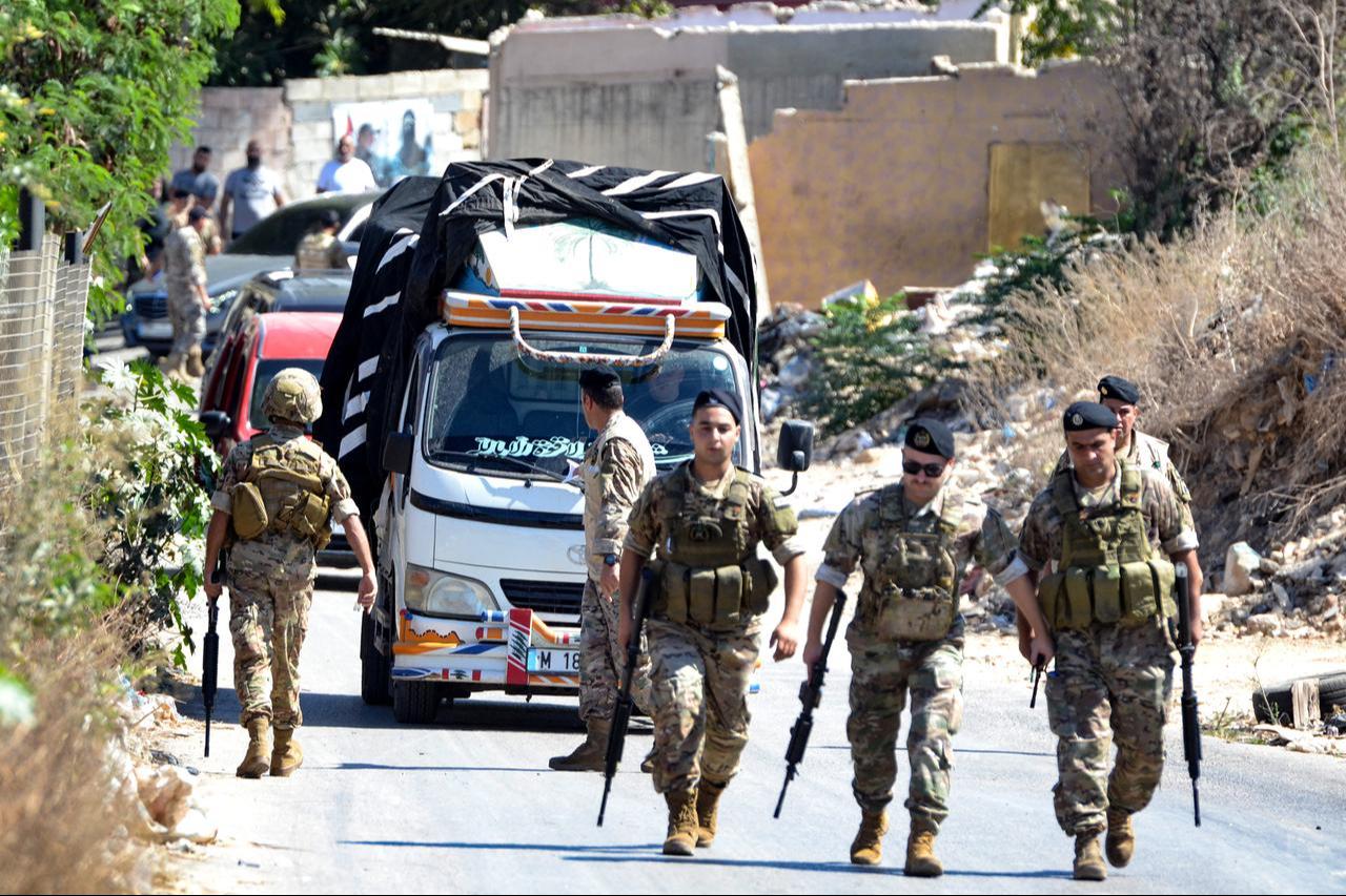 Lebanese army soldiers stand guard as a truck loaded with weapons leaves the Palestinian refugee camp of Beddawi, near the northern city of Tripoli, Sept. 13, 2025. (AFP Photo)