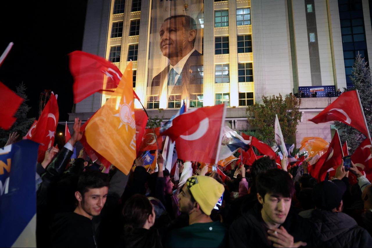 Supporters of President Erdogan wave flags outside the AK Party headquarters after presidential and parliamentary elections in Ankara, Türkiye, May 15, 2023. (AFP Photo)
