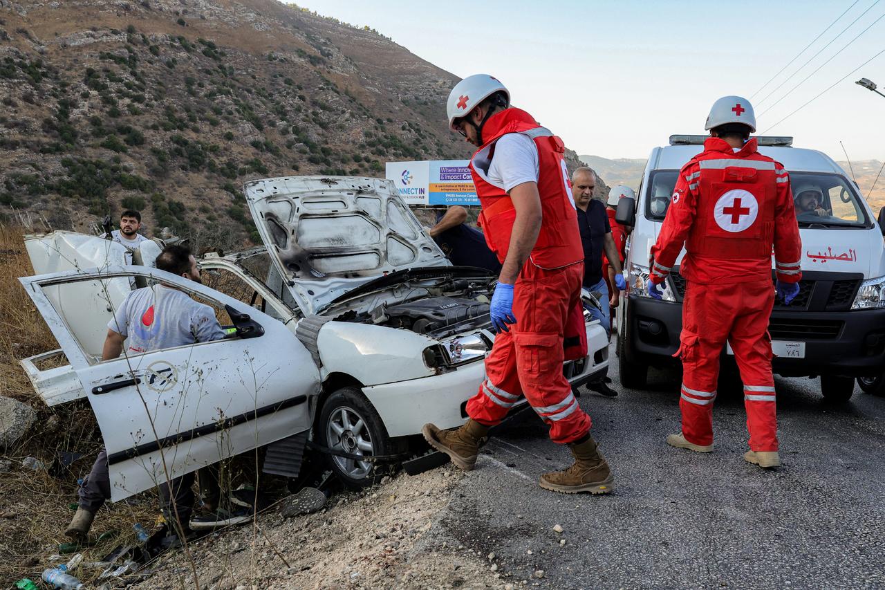 First responders and security forces members gather at the site of an Israeli strike on a vehicle on the Khardali road in south Lebanons Marjayoun area, Sept 20, 2025. (AFP Photo)