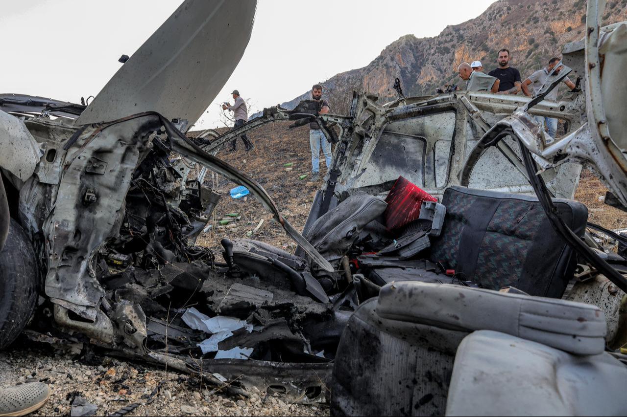 First responders and security forces' members gather at the site of an Israeli strike on a vehicle on the Khardali road in south Lebanon's Marjayoun area on Sept. 20, 2025. (AFP Photo)