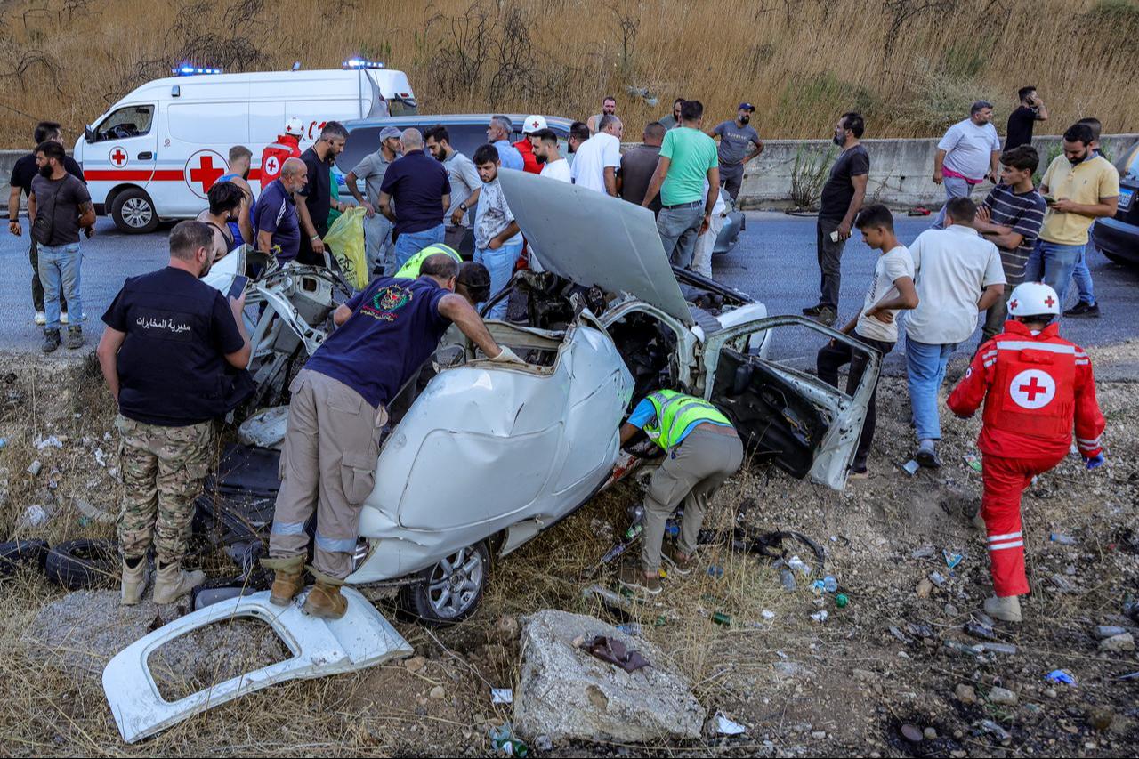 First responders and security forces' members gather at the site of an Israeli strike on a vehicle on the Khardali road in south Lebanon's Marjayoun area on Sept. 20, 2025. (AFP Photo)