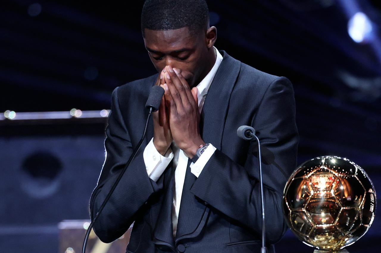 Paris Saint-Germains French forward Ousmane Dembele reacts after receiving the Ballon dOr award during the 2025 Ballon dOr France Football award ceremony at the Theatre du Chatelet in Paris on Sep. 22, 2025. (AFP Photo)