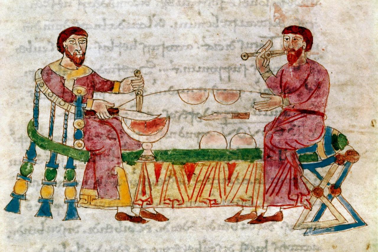 Two men dining, illustration from De Mensis et Escis in the manuscript De Universo by Rabanus Maurus, 9th century. (Photo via meisterdrucke.com)