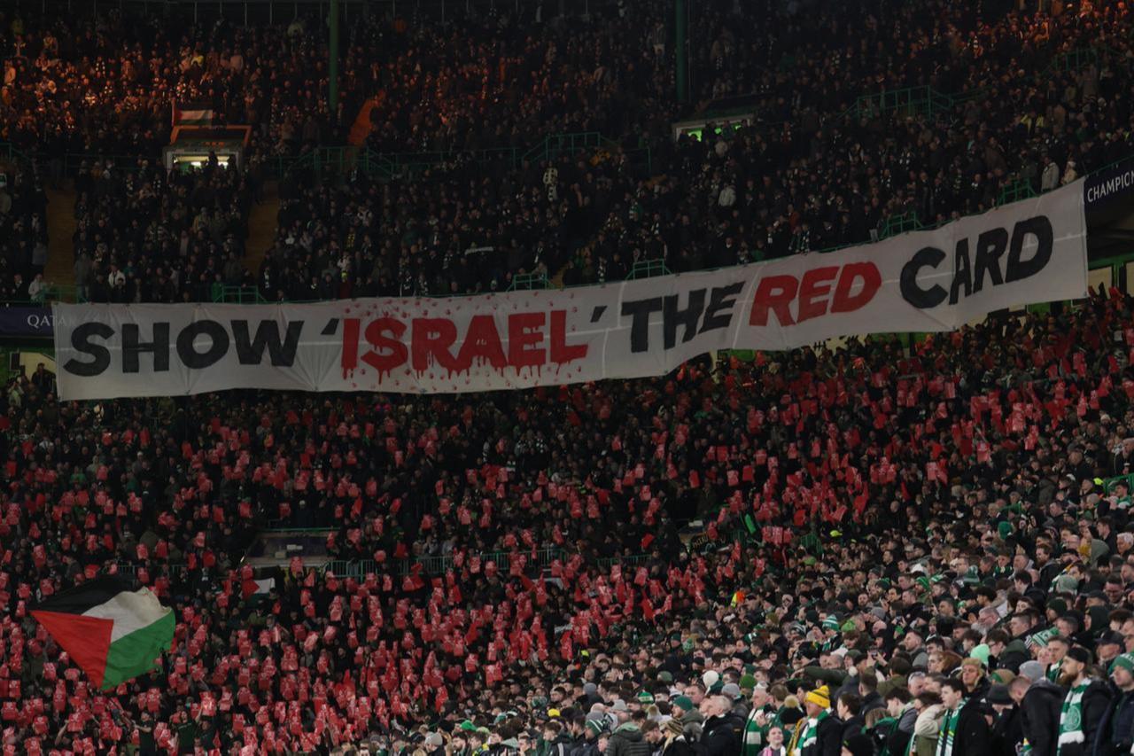 Celtic fans unveil a banner reading Show Israel The Red Card during the UEFA Champions League play-off first leg football match between Celtic and Bayern Munich at Celtic Park stadium in Glasgow, Scotland, February 12, 2025. (@football_tweet via X)