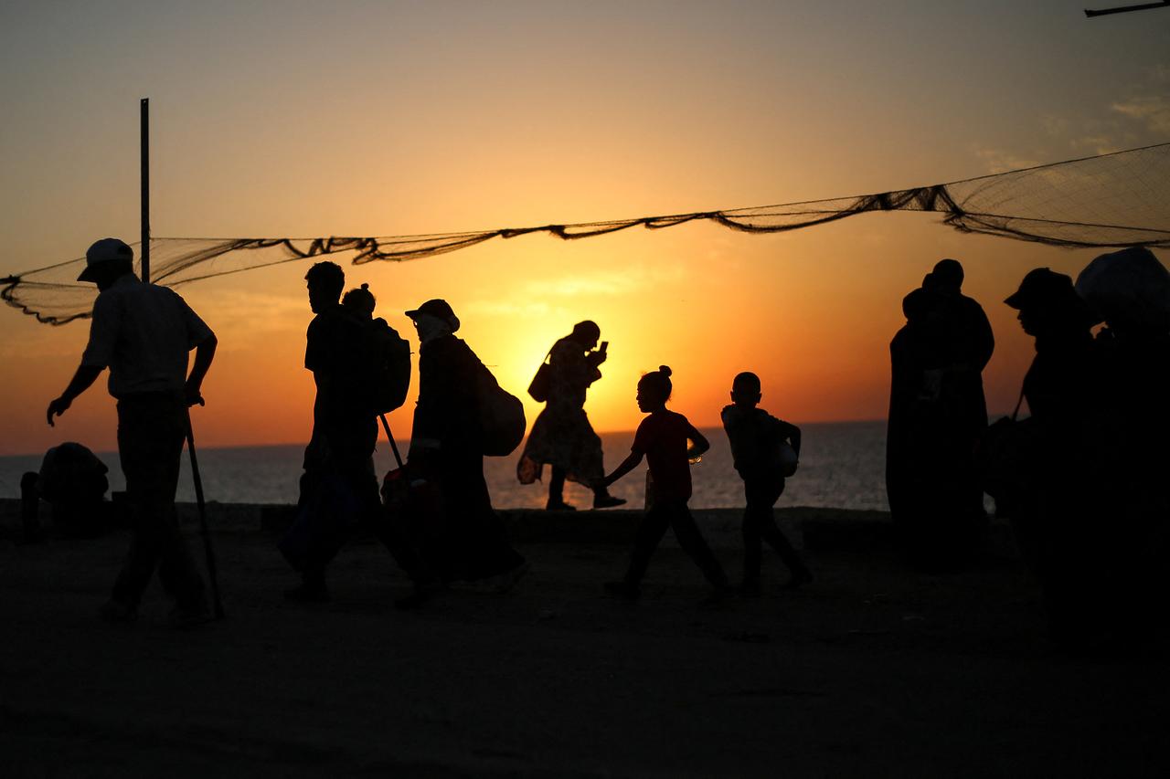 Displaced Palestinians move with their belongings southwards on a road in the Nuseirat refugee camp area in the central Gaza Strip on September 23, 2025. (AFP Photo)