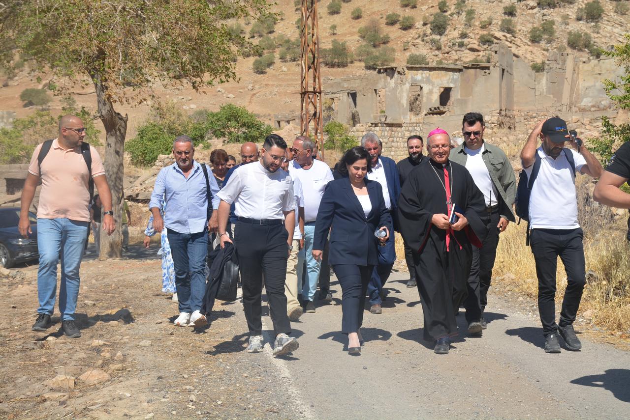 Assyrians from France walk through Kosreli village in Türkiye’s Sirnak province, returning to the land their families left decades ago, Sept. 23, 2025. (AA Photo)