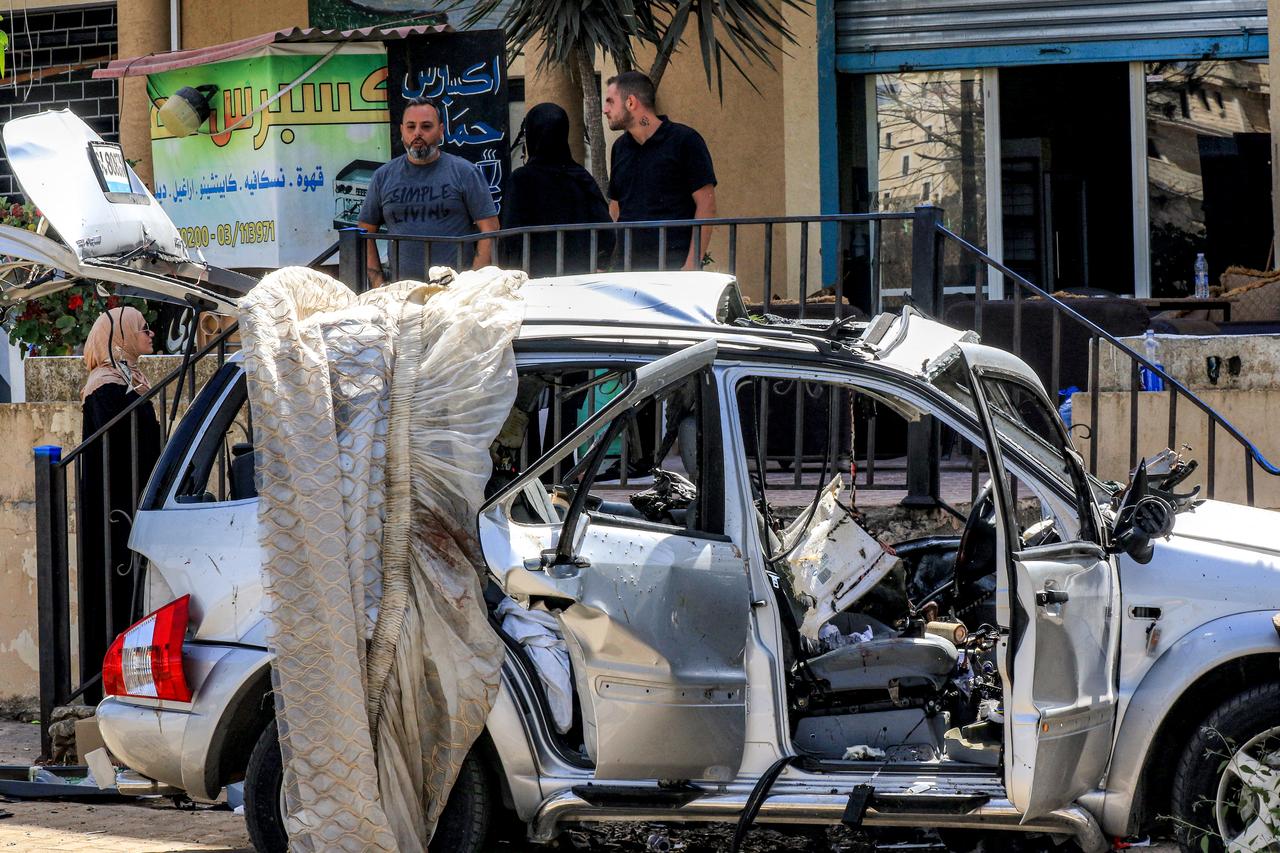 People inspect the wreckage of a vehicle that was hit the previous day in an Israeli drone strike, in Bint Jbeil in southern Lebanon on September 22, 2025. (AFP Photo)