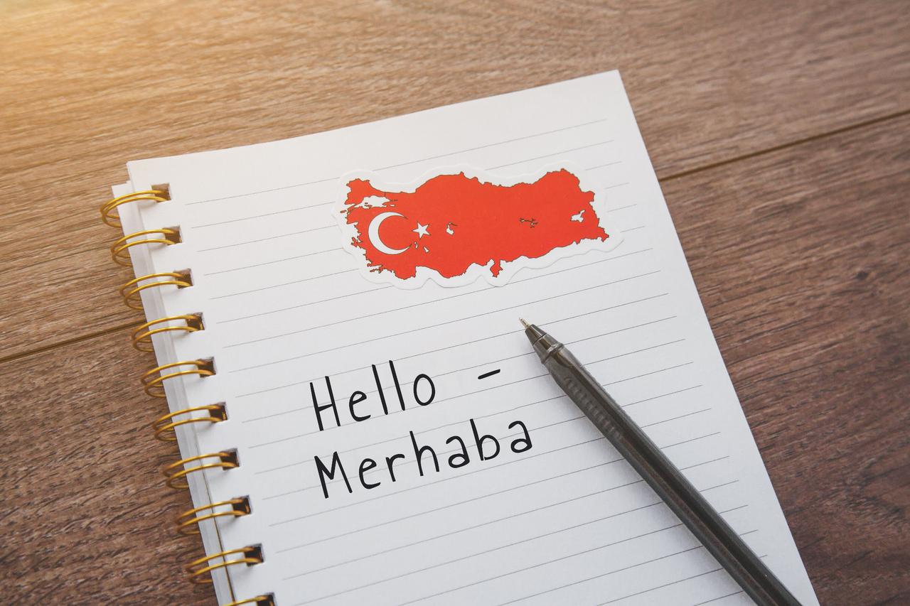 Notebook with a Türkiye map sticker and the phrase “Hello – Merhaba” written in English and Turkish, symbolizing cultural connection. (Adobe Stock Photo)