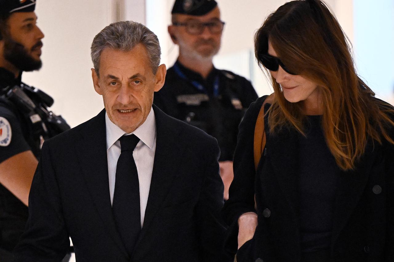 Former French president Nicolas Sarkozy with his wife Carla Bruni arrives for the verdict in his trial for illegal campaign financing from Libya for his successful 2007 presidential bid, at the Tribunal de Paris courthouse in Paris, France, Sept. 25, 2025. (AFP Photo)