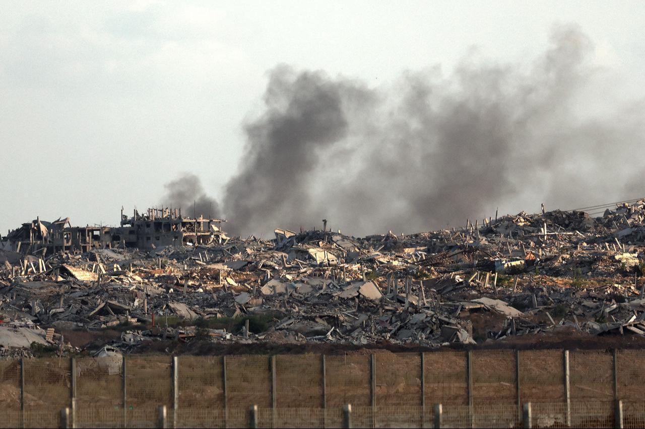 This picture taken from a position at Israels border with the Gaza Strip shows smoke billowing behind destroyed buildings during an Israeli strike on the besieged Palestinian territory on Sept. 25, 2025. (AFP Photo)