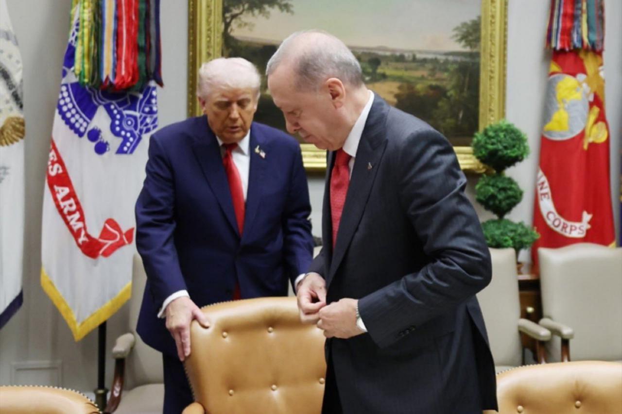 U.S. President Donald Trump adjusts a chair for Turkish President Recep Tayyip Erdogan during their meeting at the White House in Washington, D.C., September 25, 2025. (Photo via X/@turkiyegazetesi)