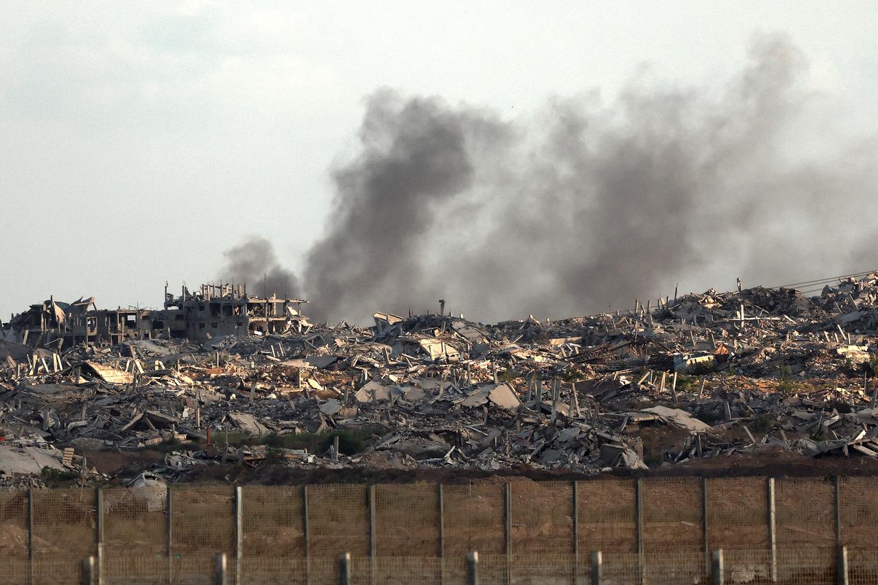 This picture taken from a position at Israels border with the Gaza Strip shows smoke billowing behind destroyed buildings during an Israeli strike on the besieged Palestinian territory on Sept. 25, 2025. (AFP Photo)