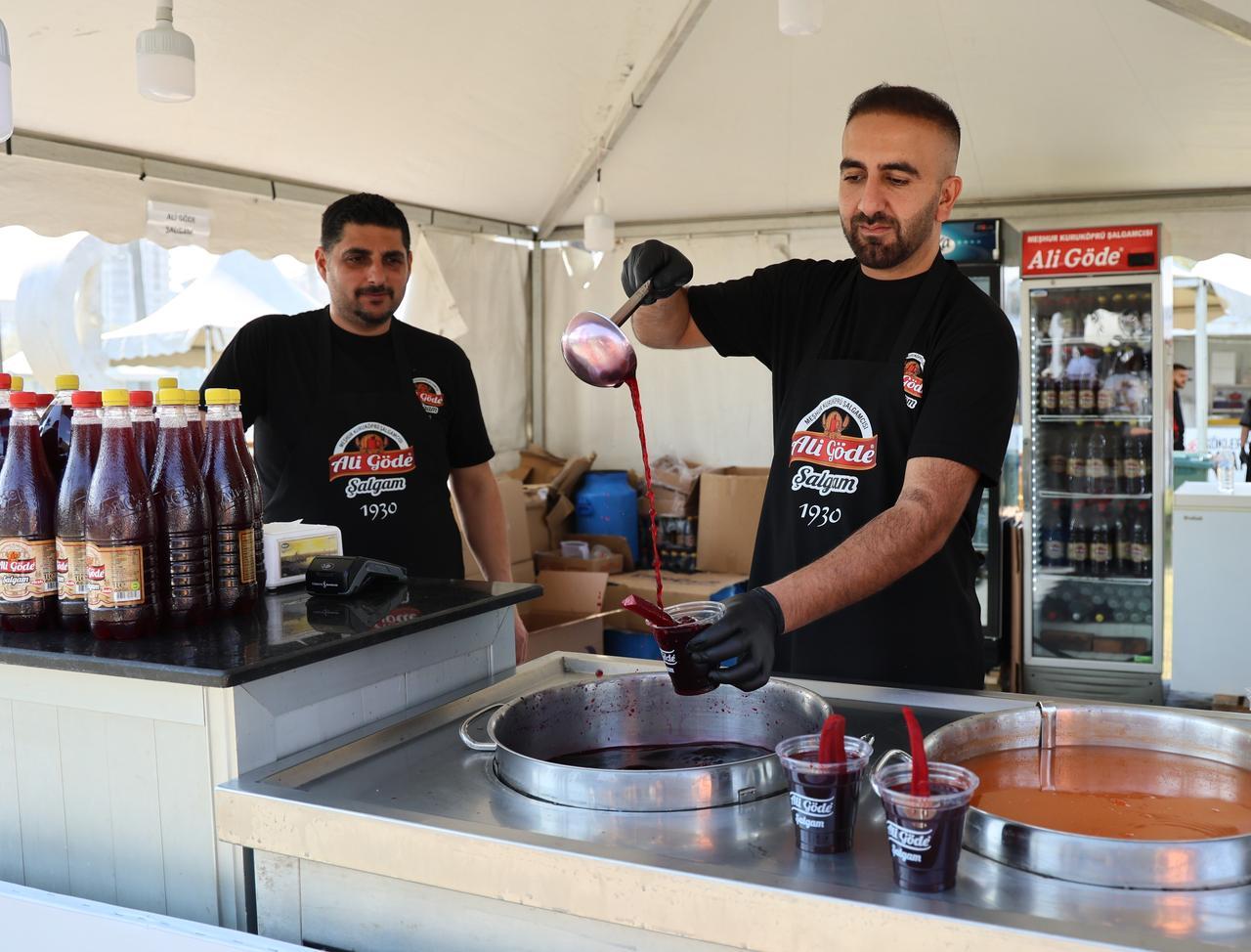 Vendors serve salgam, a traditional fermented turnip juice, at the 8th International Taste of Adana Festival in Adana, Türkiye, Oct. 18, 2025. (IHA Photo)