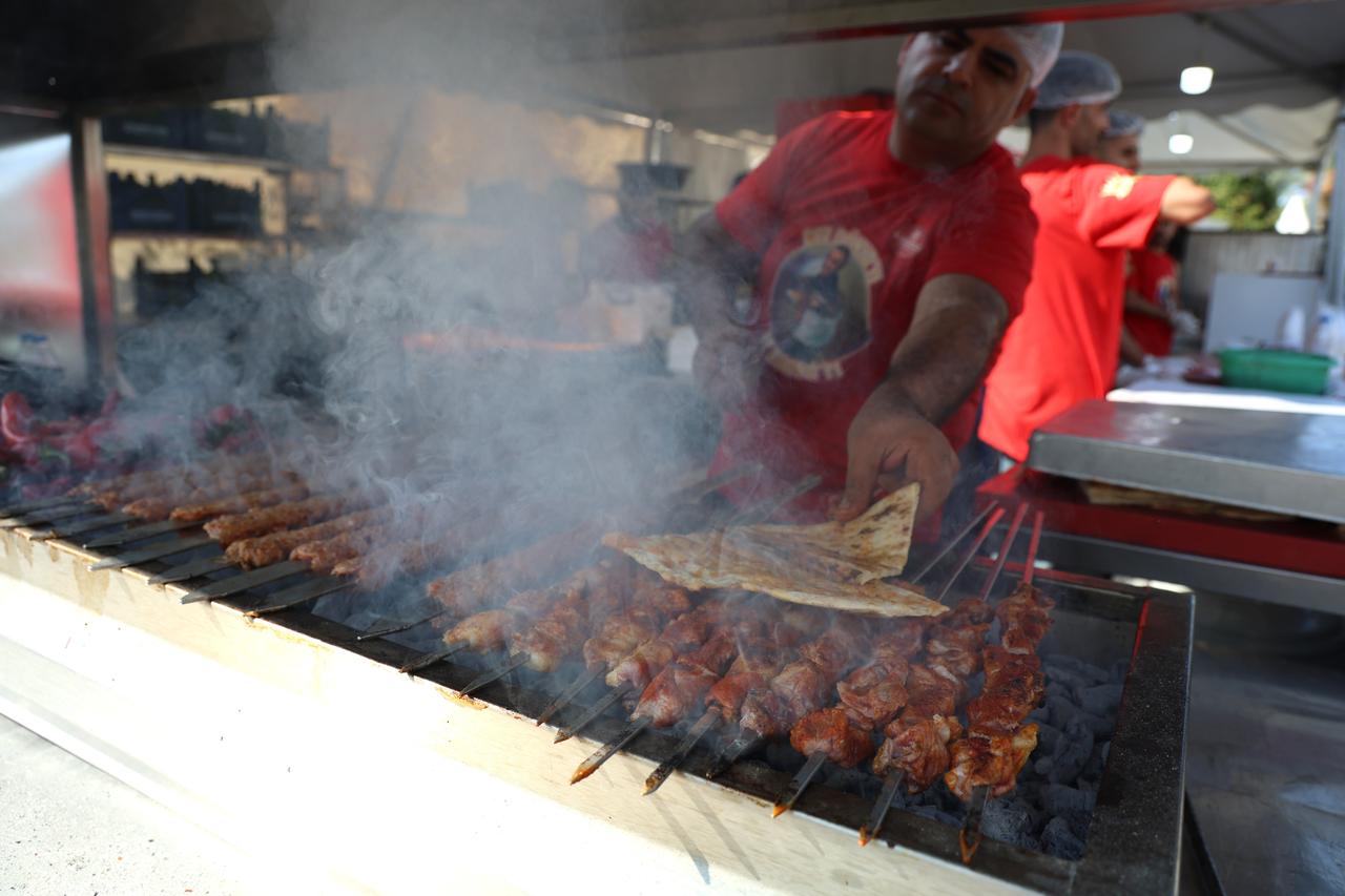 A cook grills skewers of Adana kebab at the 8th International Taste of Adana Festival in Adana, Türkiye, Oct. 18, 2024. (IHA Photo)