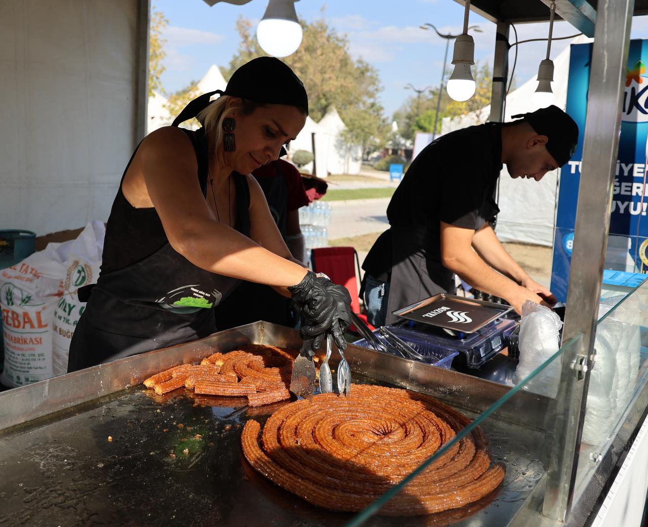 Vendors prepare fresh desserts for visitors at the 8th International Taste of Adana Festival in Adana, Türkiye, Oct. 18, 2024. (IHA Photo)