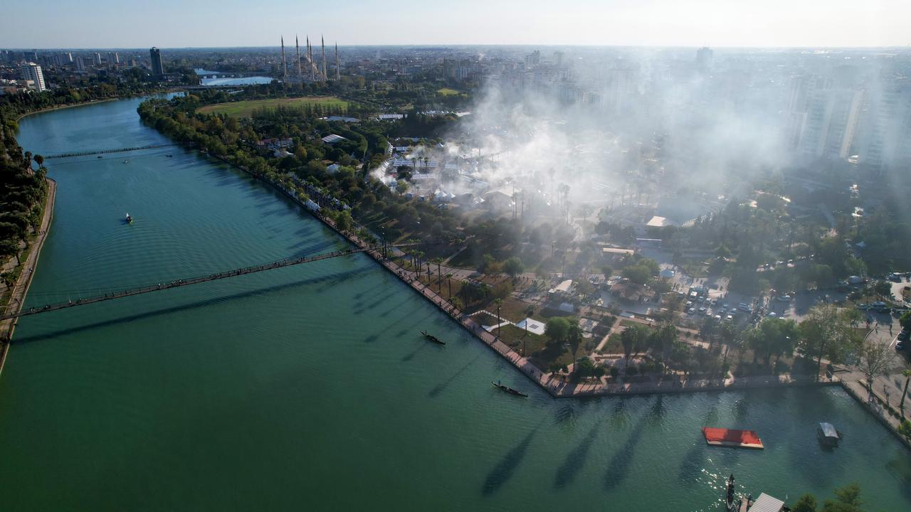 Smoke rises from grills as crowds gather along the Seyhan River at the 8th International Taste of Adana Festival in Adana, Türkiye, Oct. 18, 2024. (IHA Photo)
