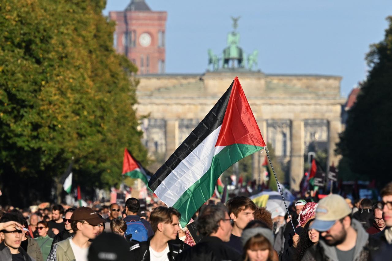 Participants march with Palestinian flags during a demonstration under the motto Draw the red line with us: Together for Gaza! near the Brandenburg Gate in the center of Berlin on Sep. 27, 2025. (AFP Photo)