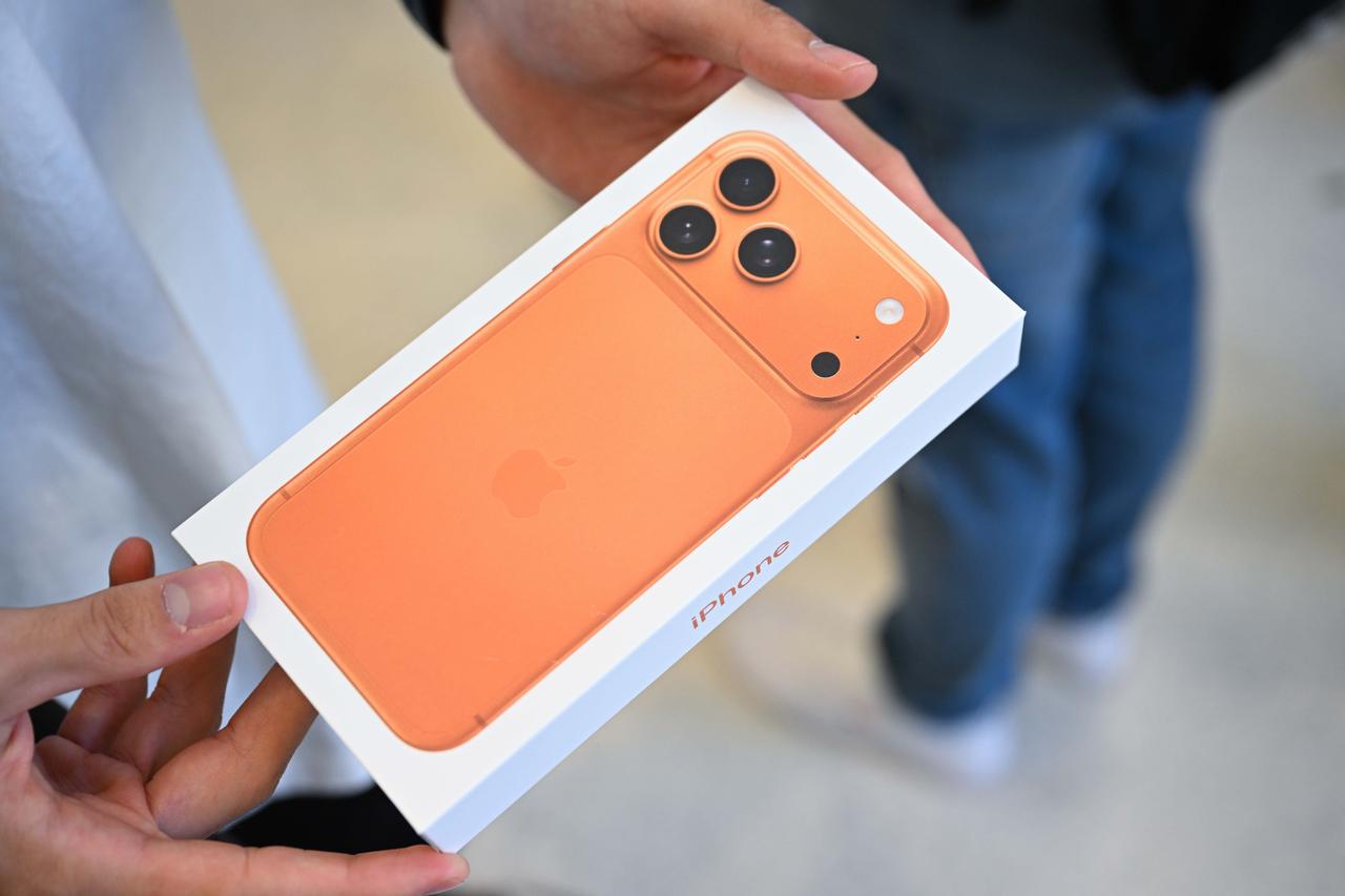 A customer holds the new iPhone 17 Pro Max during its sales debut at the Apple Store on Regent Street in London, United Kingdom, September 19, 2025. (AA Photo)