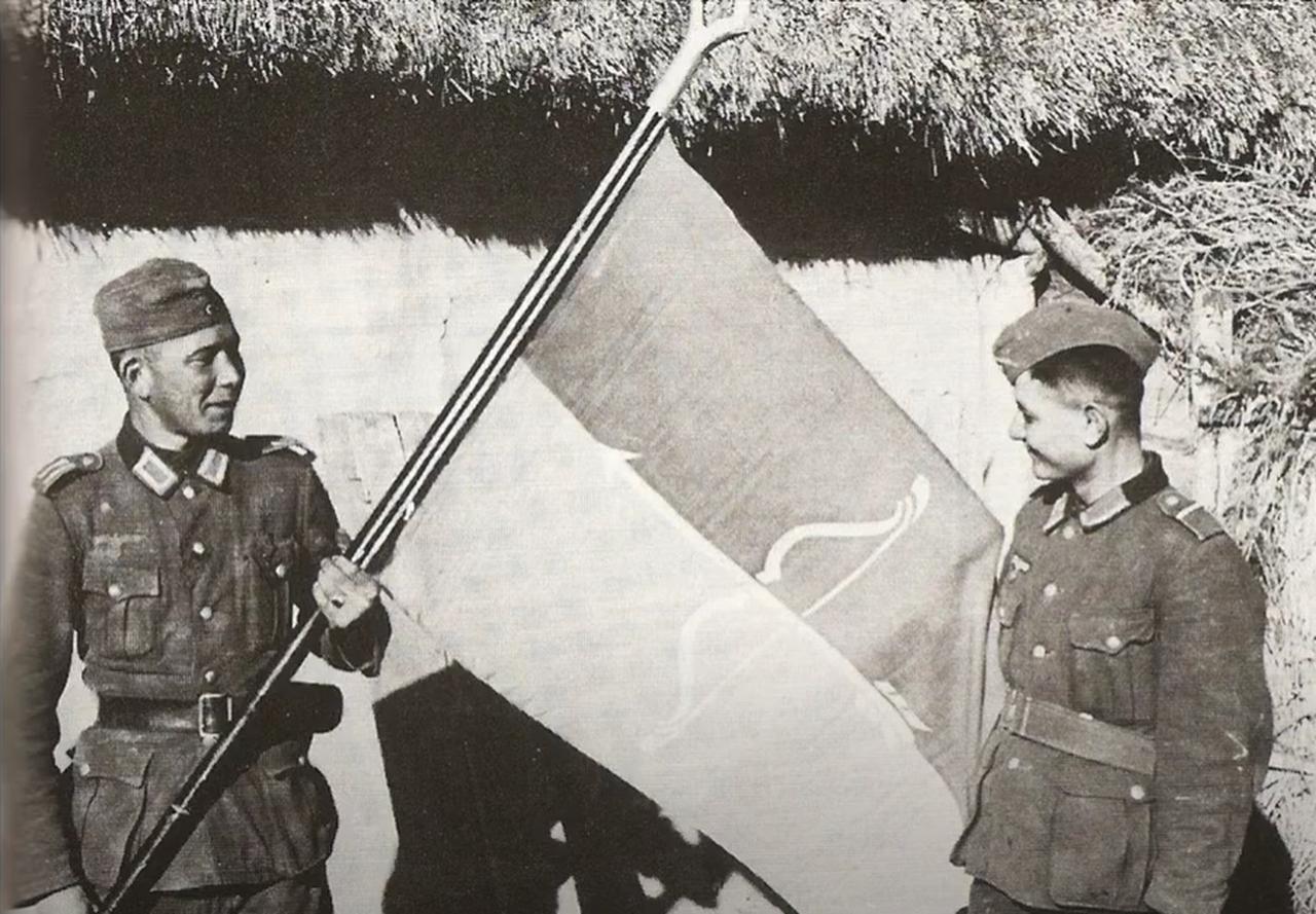 Two soldiers of the Turkestan Legion holding a unit flag. (Photo via German Federal Archives)