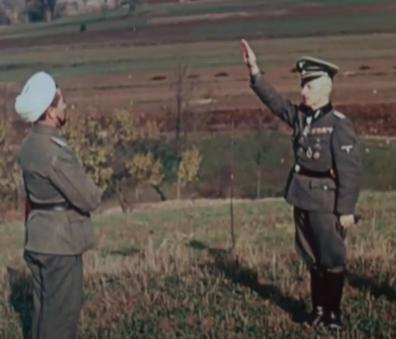 An SS officer salutes a Muslim cleric attached to the Turkestan Legion. (Photo via German Federal Archives)