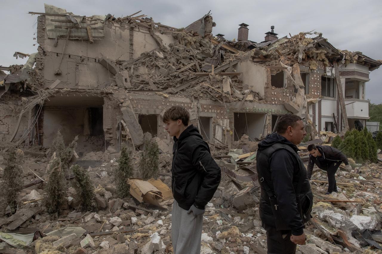 People walk at the site of heavily damaged residential buildings following a Russian air attack on the outskirts of Kyiv, on September 28, 2025. (AFP Photo)
