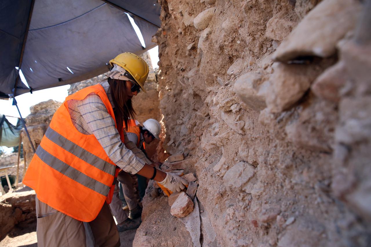 Excavation team members clean and document wall remains during archaeological work in Tralleis, Aydin, Türkiye, Sept. 28, 2025. (AA Photo)