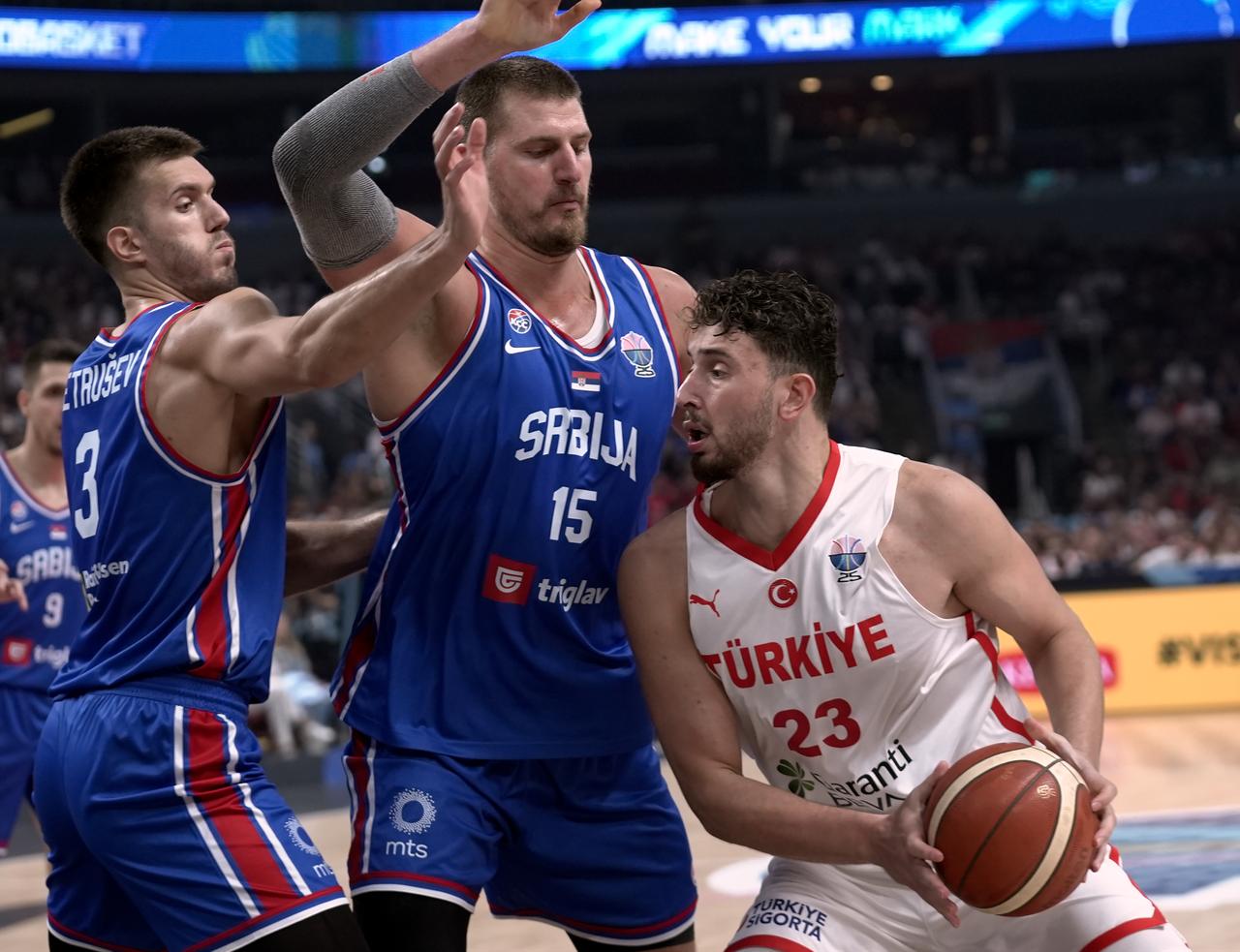 Alperen Sengun (23) of Türkiye in action against Nikola Jokic (15) of Serbia during the FIBA EuroBasket 2025 Group A basketball match between Türkiye and Serbia in Riga, Latvia on Sep. 03, 2025. (AA Photo)