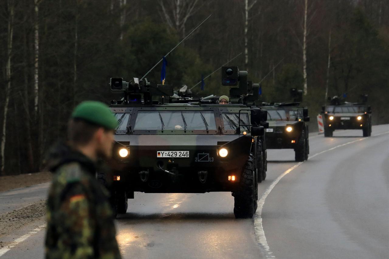 A convoy of armoured vehicles of German armed forces Bundeswehr arrives at the NATO enhanced Forward Presence Battle Group Battalion in Rukla, Lithuania, February 17, 2022. (AFP Photo)