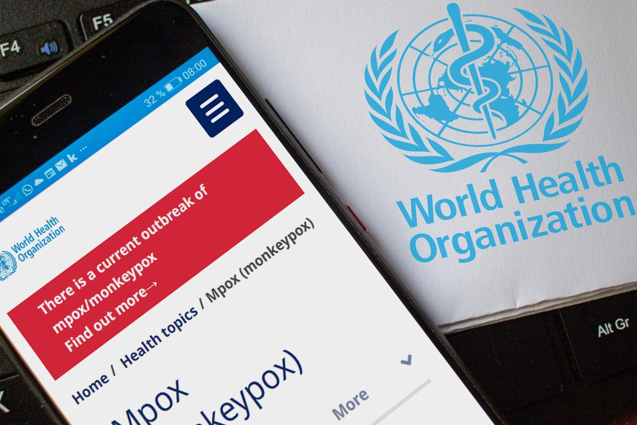 A smartphone displays a website while the World Health Organization logo highlights a current mpox outbreak caused by the monkeypox virus. (Adobe Stock Photo/ Jens Hertel - stock.adobe.com)