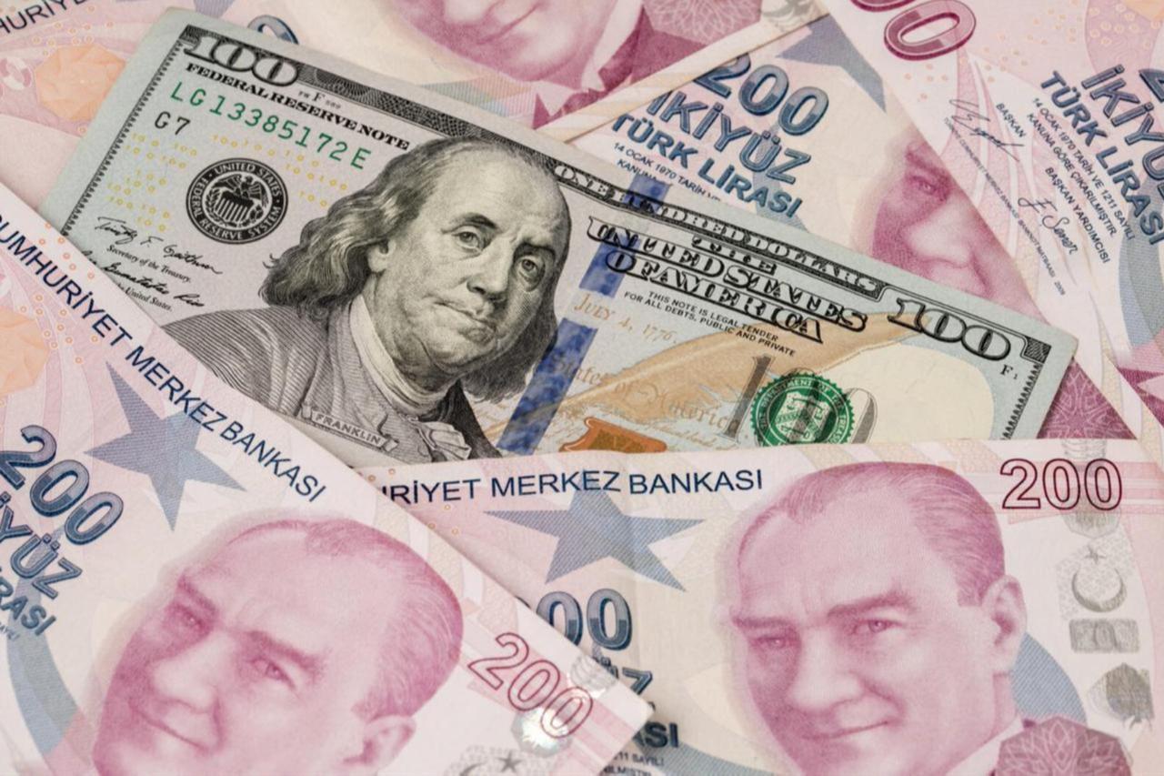 US dollars and Turkish Liras stacked, covering the entire screen. (Adobe Stock Photo)