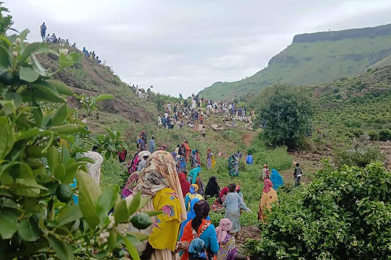 This handout image made available by the Sudan Liberation Movement/Army (SLM) shows people inspecting the debris after a landslide devastated the village of Tarasin in Sudans Jebel Marra area on September 1, 2025. (AFP Photo)