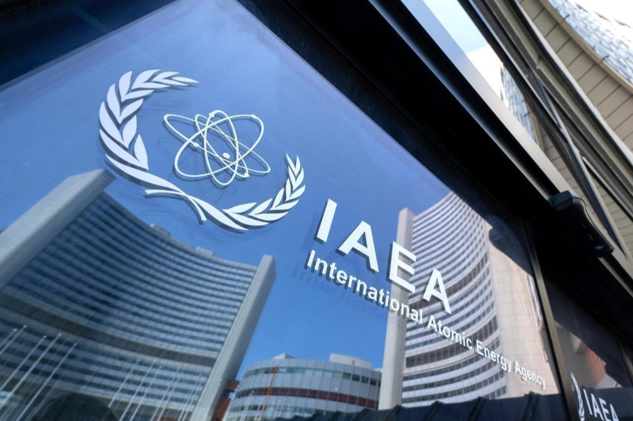 Buildings of the International Atomic Energy Agency (IAEA) headquarters reflect in doors with the agencys logo during the IAEA’s Board of Governors meeting in Vienna, Austria on June 13, 2025. (AFP Photo)