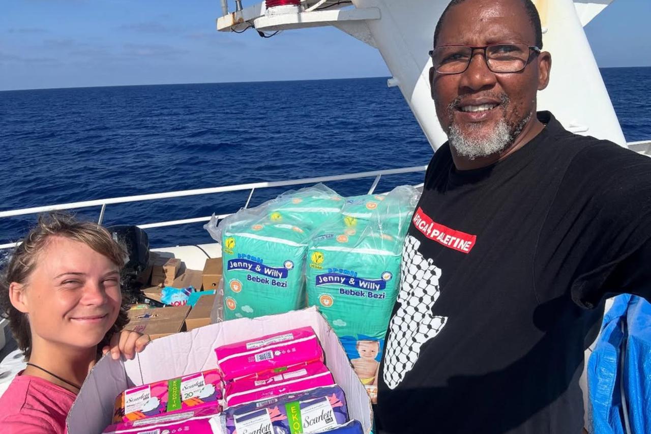 Greta Thunberg with Nelson Mandela’s grandson on the Sumud flotilla, receiving a Turkish aid consignment. September 29, 2025. ( Photo via Instagram / @Nkosi Zwelivelile  )