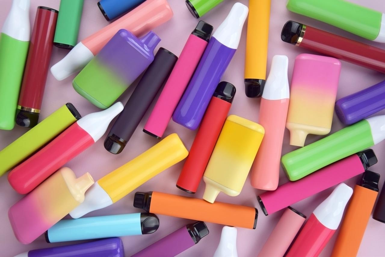 Colorful disposable electronic cigarettes displayed together, designed to attract young users with playful packaging and bright gradients. (Adobe Stock Photo)
