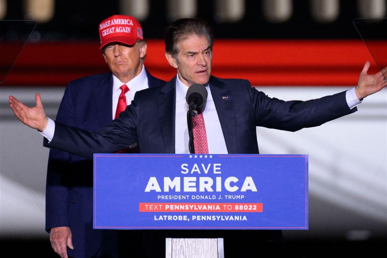 Then-former U.S. President Donald Trump (L) looks on as Republican Senatorial candidate Dr. Mehmet Oz speaks during a  Save America  rally ahead of the midterm elections at Arnold Palmer Regional Airport in Latrobe, Pennsylvania, U.S., November 5, 2022. (AFP Photo)
