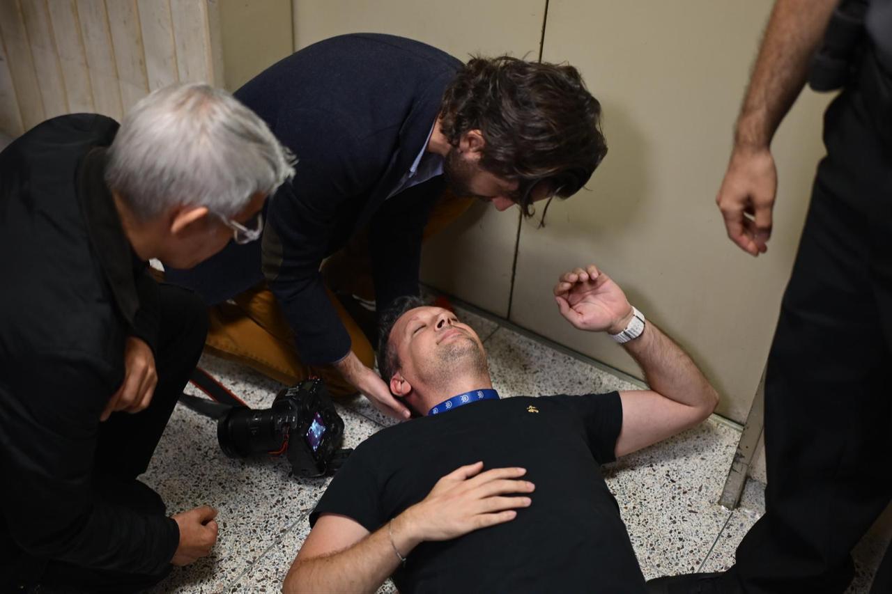 Anadolu Agency chief cameraman Vural Elibol is on the ground after falling and hitting his head on the ground following a rough intervention by ICE officers, New York, Sept. 30, 2025. (AA Photo)